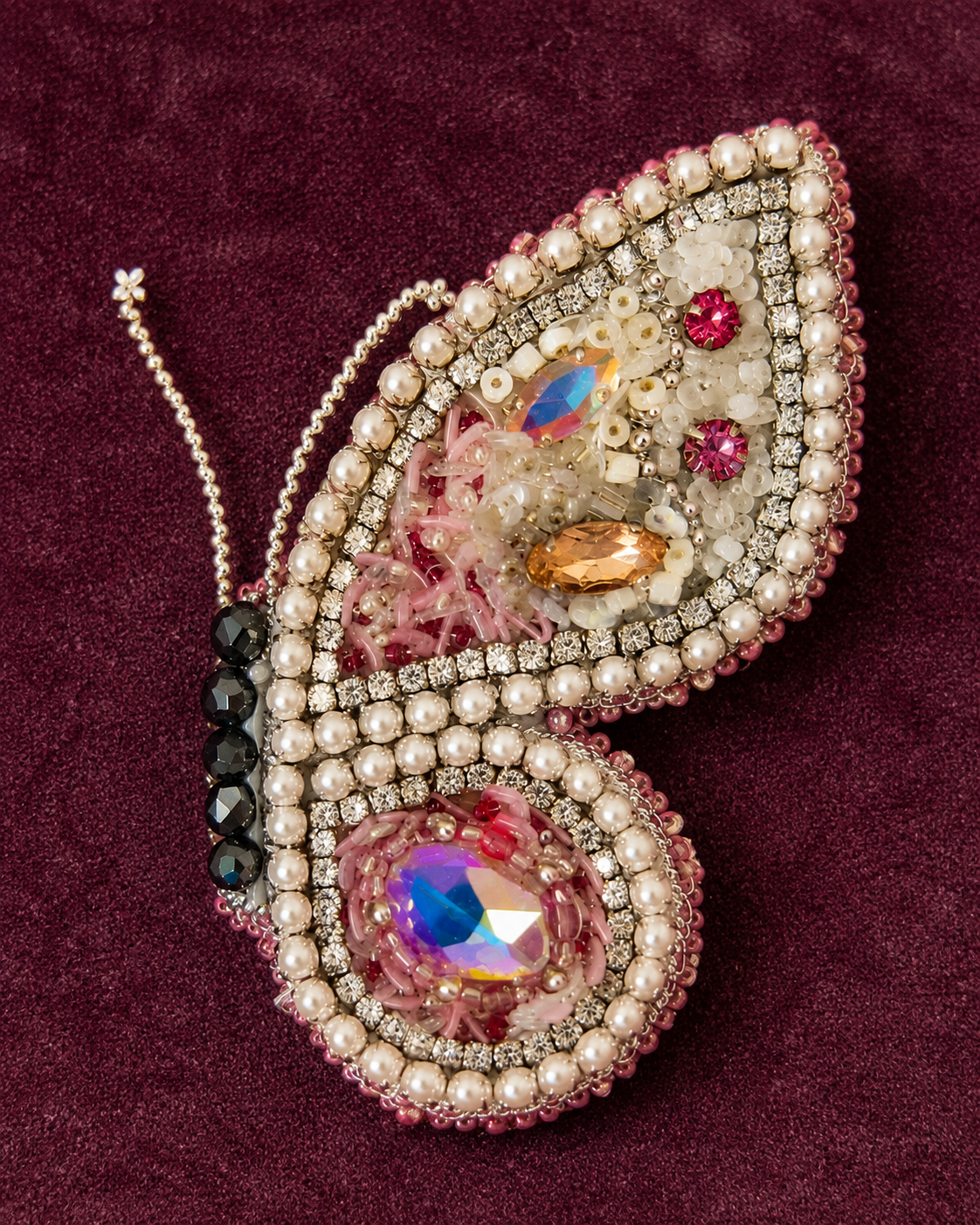 Butterfly Light brooch on burgundy velvet